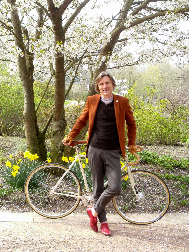 Michael Droste steht vor seinem Fahrrad am Wegrand